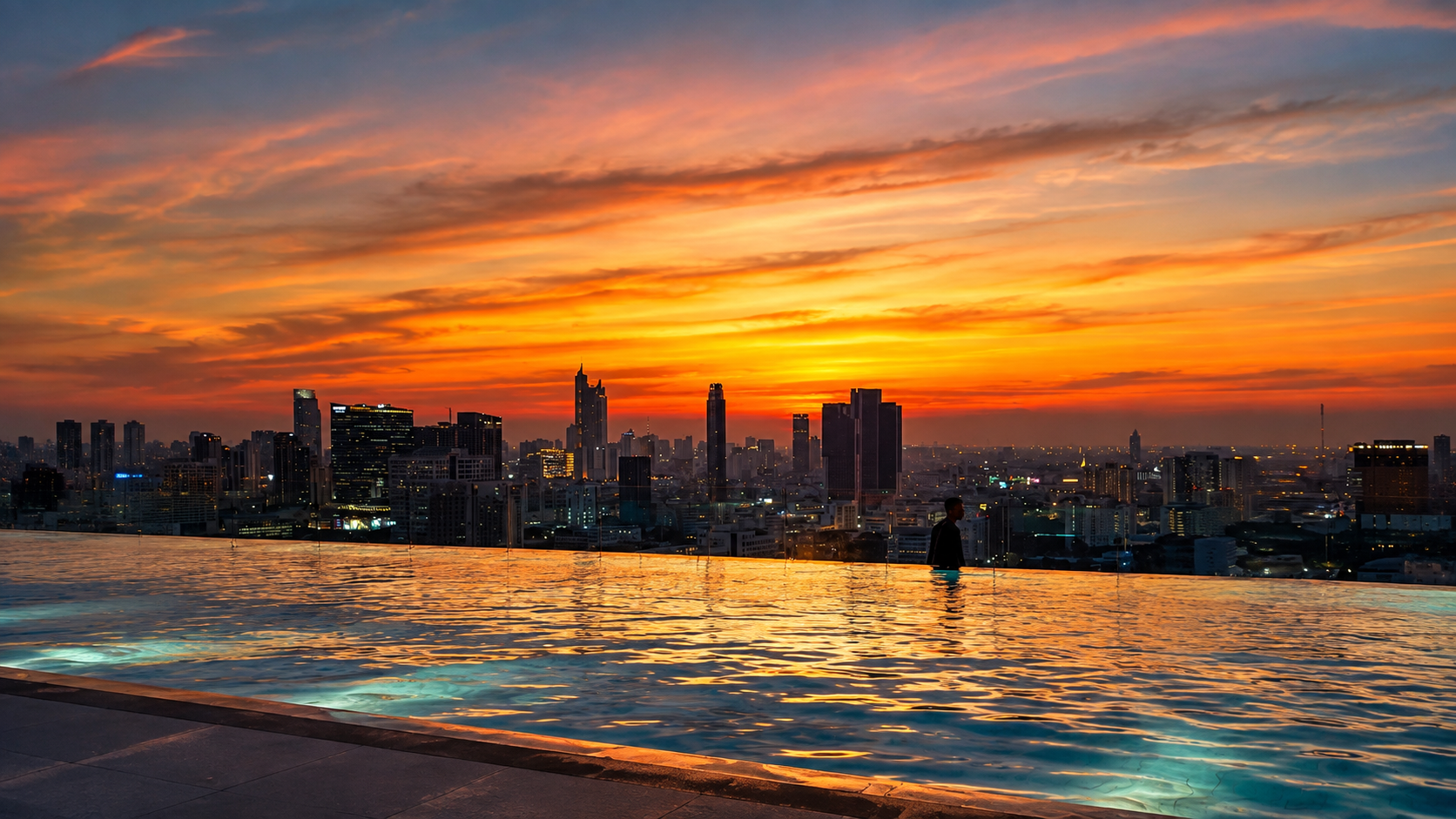 City skyline at sunset over water